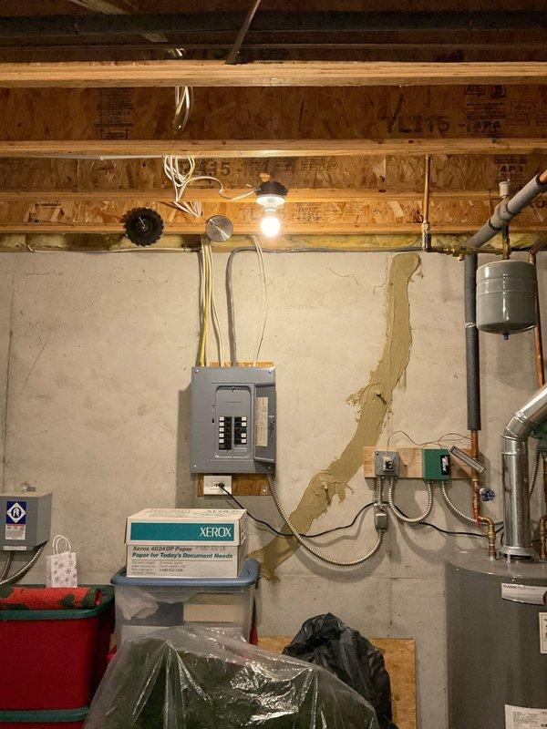 Conducted site assessment for electrical estimate to install an EV charger in the garage and add an additional outdoor outlet. Evaluated existing electrical panel capacity and circuit availability in the basement utility area to determine feasibility of supporting the new 240V EV charging circuit and additional 120V outdoor receptacle. Documented current electrical infrastructure including main service panel configuration, available breaker spaces, and wire routing pathways through unfinished basement area to proposed installation locations.