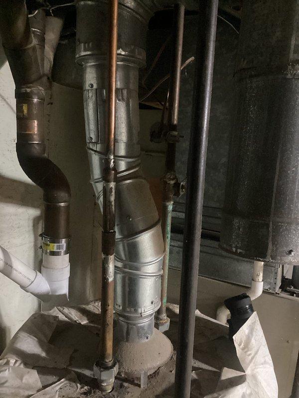 Provided estimate for replacement of existing gas-fired tall 40-gallon water heater located in basement utility room. Assessed current installation including copper supply piping, gas connections, and venting configuration alongside furnace unit in unfinished mechanical space with concrete floor and exposed joists.