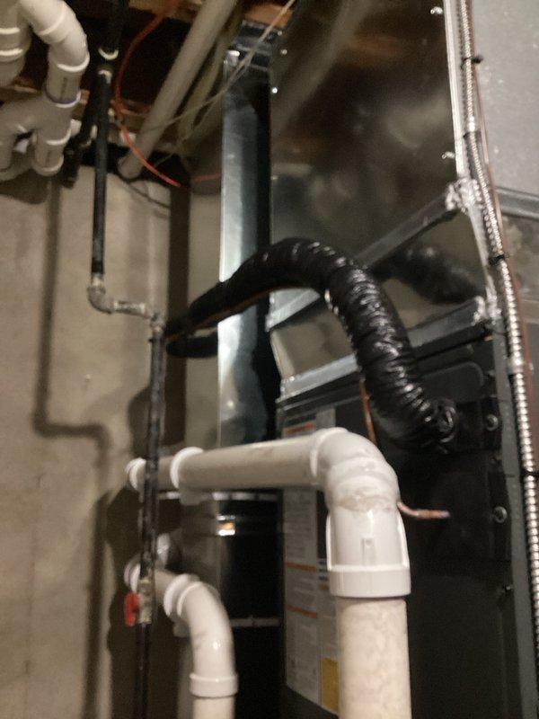 Completed full installation of new furnace and air conditioning system. Installed air handler unit with associated PVC drainage lines, flexible ductwork connections, and rigid metal ductwork distribution system. All refrigerant lines, condensate drains, and electrical connections properly installed and secured per manufacturer specifications.