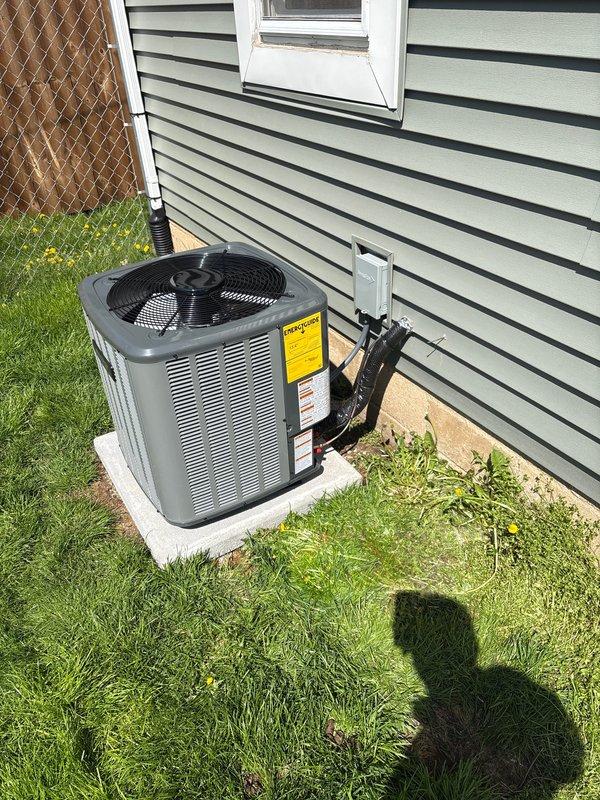 Completed full air conditioning system replacement including outdoor condensing unit and indoor air handler components. Installed new outdoor unit on concrete pad with proper refrigerant line routing along exterior wall, secured with mounting brackets. Replaced indoor ductwork assembly in basement utility area, including vertical rectangular duct section and transition pieces with proper sealing at all metal joints and connections.