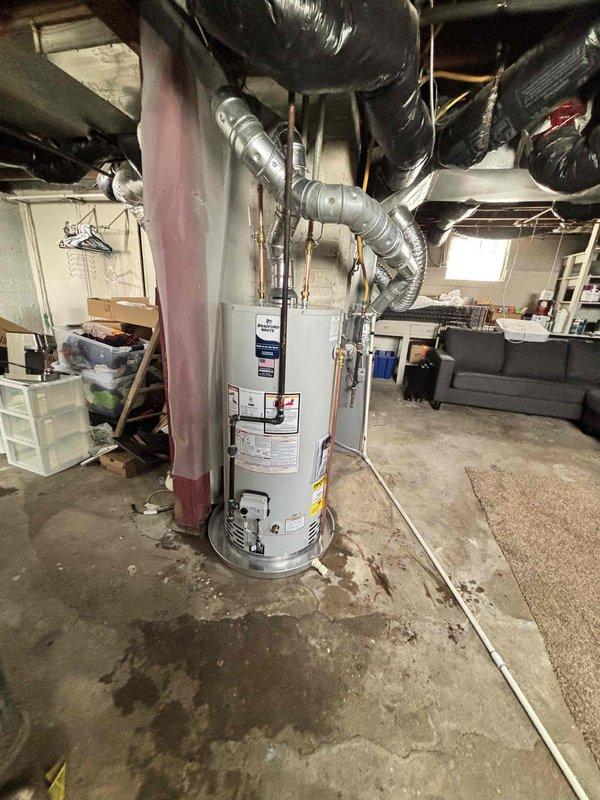 Completed full residential water heater replacement in basement utility area. Removed existing unit and installed new Bradford White water heater with proper copper piping connections, brass fittings, and metallic flexible venting. Ensured all manufacturer specifications, safety labels, and warning notices were properly displayed. Verified proper connections to existing plumbing system and electrical panel, tested unit operation, and confirmed compliance with residential installation standards.