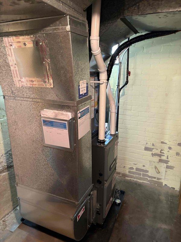 Completed full HVAC system replacement including new furnace and air conditioning unit. Installed outdoor condensing unit on existing concrete pad at exterior corner of residence with proper electrical disconnect and conduit routing. Mounted new furnace in basement mechanical room with associated air handler, connected PVC condensate drainage, and integrated all ductwork connections to existing system.