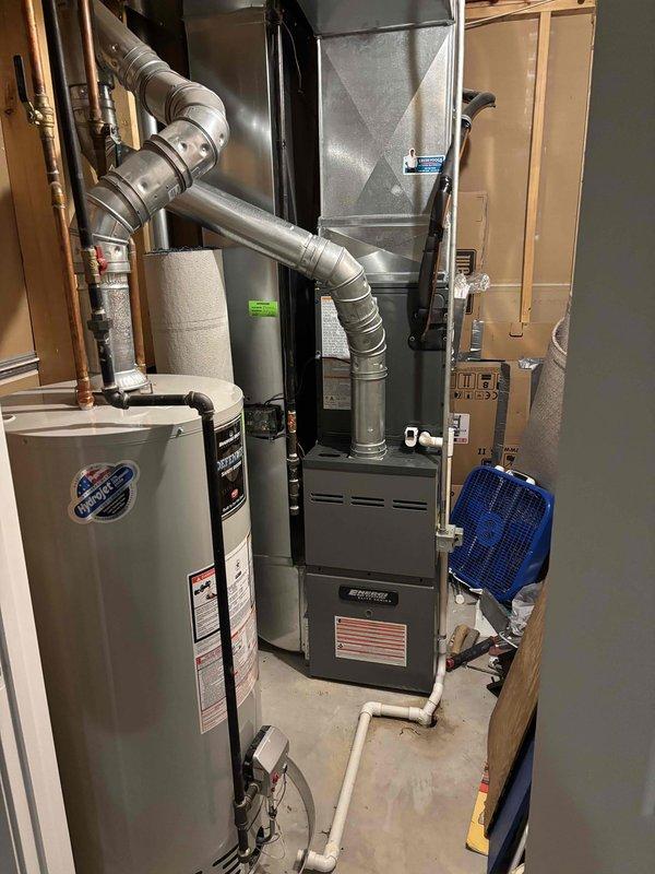 Completed full HVAC system installation including new air conditioning condenser unit and indoor air handler. Installed outdoor condenser on concrete pad with proper electrical disconnect and conduit routing along exterior wall. Connected refrigerant lines, established proper drainage, and integrated new equipment with existing furnace and ductwork system in mechanical room. Verified all electrical connections, tested system operation, and confirmed proper airflow throughout. Installation includes updated plenum connections and complete system startup with performance verification.