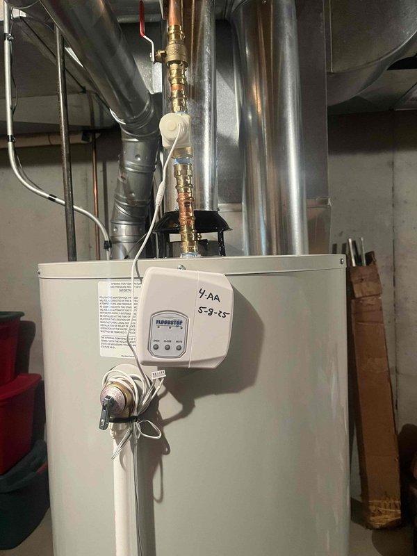 Responded to no hot water call and found 27-year-old Lochinvar water heater completely inoperative. Upon inspection, determined unit had reached end of serviceable life and was beyond economical repair. Documented existing installation with photos showing unit configuration, piping connections, and basement utility room layout for replacement planning purposes.