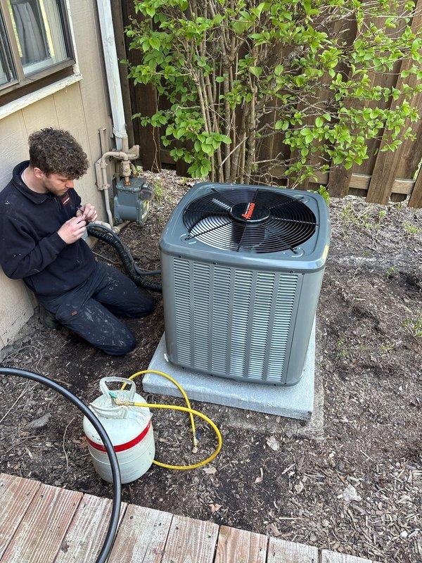 Completed full AC system replacement at residential property. Removed existing air conditioning unit and installed new condenser on exterior concrete pad with proper refrigerant recovery procedures. Connected refrigerant lines using standard service hoses and performed system evacuation and charging. Verified indoor furnace connections and ensured proper integration with existing HVAC infrastructure including ductwork and PVC condensate drainage. System tested and confirmed operational with proper airflow and cooling performance.