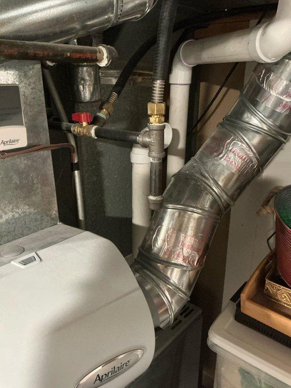 Conducted on-site evaluation of existing residential air conditioning system to provide replacement estimate. Inspected outdoor condensing unit showing signs of age and weathering, documented current installation including electrical disconnect, refrigerant line set routing, and concrete pad placement. Assessed indoor HVAC components including furnace/air handler connections, humidification system integration, and existing ductwork configuration to determine compatibility requirements for new equipment installation.