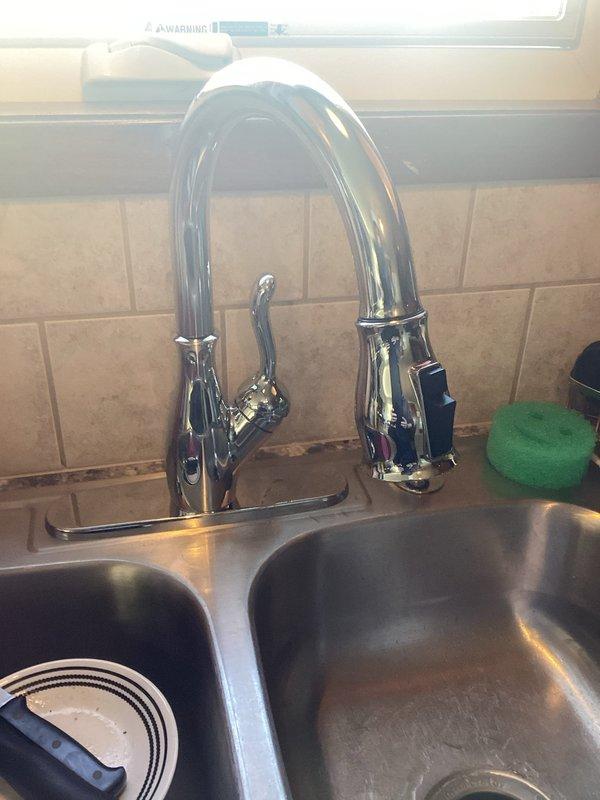 Responded to service call for leaking kitchen faucet and non-functional garbage disposal in 15-year-old residential property. Inspected chrome pull-down faucet with single-handle design and identified source of leak at base connection points. Tightened mounting hardware and supply line connections beneath sink, verified proper seal on faucet base plate against countertop surface. Examined under-sink plumbing configuration including P-trap assembly, copper supply lines, and PVC drain pipes to ensure no secondary leak points. Assessed garbage disposal unit for operational issues, tested electrical connections and reset mechanisms. Secured all flexible supply lines and drainage connections with appropriate fasteners. Conducted water flow test to confirm leak resolution and verified proper drainage through disposal and trap assembly. All fixtures restored to proper working condition with no active leaks detected upon completion.
