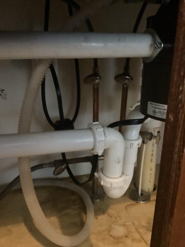 Responded to service call for leaking kitchen faucet and non-functional garbage disposal in 15-year-old residential property. Inspected chrome pull-down faucet with single-handle design and identified source of leak at base connection points. Tightened mounting hardware and supply line connections beneath sink, verified proper seal on faucet base plate against countertop surface. Examined under-sink plumbing configuration including P-trap assembly, copper supply lines, and PVC drain pipes to ensure no secondary leak points. Assessed garbage disposal unit for operational issues, tested electrical connections and reset mechanisms. Secured all flexible supply lines and drainage connections with appropriate fasteners. Conducted water flow test to confirm leak resolution and verified proper drainage through disposal and trap assembly. All fixtures restored to proper working condition with no active leaks detected upon completion.