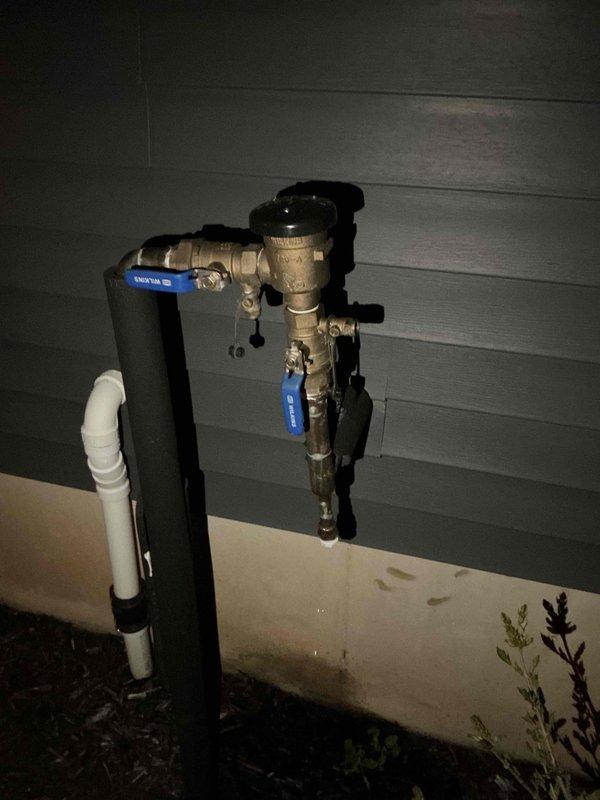 Responded to non-operational sump pump causing water backup in basement. Upon arrival after 6:30 PM, inspected sump pump system with black rubber cover plate and white PVC discharge piping. Evaluated pump mechanism, check valve assembly, and exterior discharge configuration including brass ball valves and weathered piping connections. Restored system to proper working order, eliminating backup condition and ensuring adequate water removal capability.