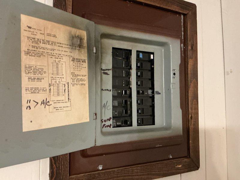 Completed electrical estimate for installation of a dedicated 120-volt circuit to power an existing sump pump system in a 50-year-old residential property. Assessed the existing electrical panel, which contained adequate breaker space and capacity for the new circuit installation. Evaluated the routing requirements from the main panel through the unfinished basement area to the sump pump location, noting the exposed stud construction and concrete floor conditions. The sump pump assembly included a vertical PVC discharge pipe system with an electronic control device mounted to the wall framing. Recommended installation specifications for a dedicated 15-amp or 20-amp circuit with appropriate GFCI protection per current electrical code requirements for wet locations.