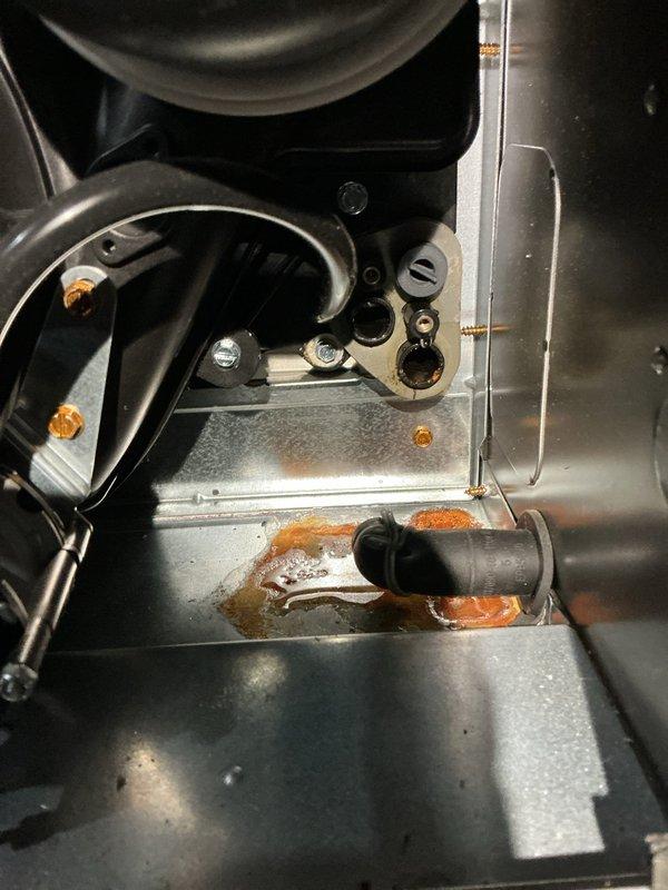 Completed annual heating and cooling tune-up on a 15-year-old Carrier system without humidifier. Performed comprehensive inspection of both furnace and air conditioning components, including visual assessment of heat exchanger, blower assembly, and refrigerant lines. Documented significant rust and corrosion around condensate drain opening in base pan, indicating potential moisture intrusion and metal deterioration that may require future attention. Verified condensate drain system operation and checked pressure switch functionality. All refrigerant line connections and compression fittings inspected and found secure with no visible leaks.