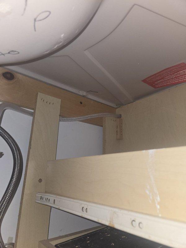Responded to quoted repair request to evaluate and provide alternative solution for dishwasher discharge hose routing. Upon inspection of under-sink plumbing configuration, assessed existing drainage system including PVC tailpiece connections, supply lines, and cabinet space constraints. Documented current installation with photos showing plumbing layout, supply line positioning, and available routing options within cabinet structure. Evaluated feasibility of alternative discharge hose path to avoid full replacement of existing drain run and provided recommendations for optimal solution.
