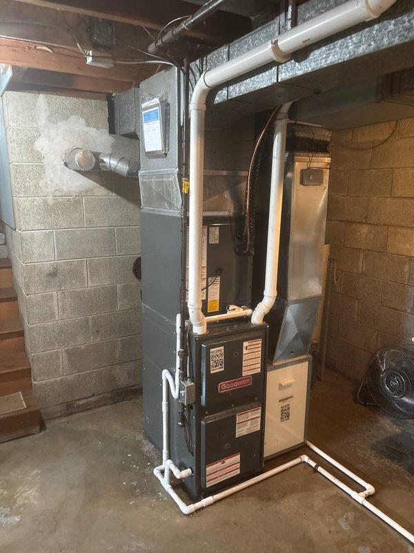 Completed full air conditioning system replacement including outdoor condensing unit and indoor air handler components. Installed new Carrier outdoor unit on existing concrete pad with proper refrigerant line connections, service valves, and line insulation. Connected system to existing furnace infrastructure in basement mechanical room with appropriate PVC condensate drainage and verified all electrical connections, refrigerant charge levels, and system operation per manufacturer specifications.