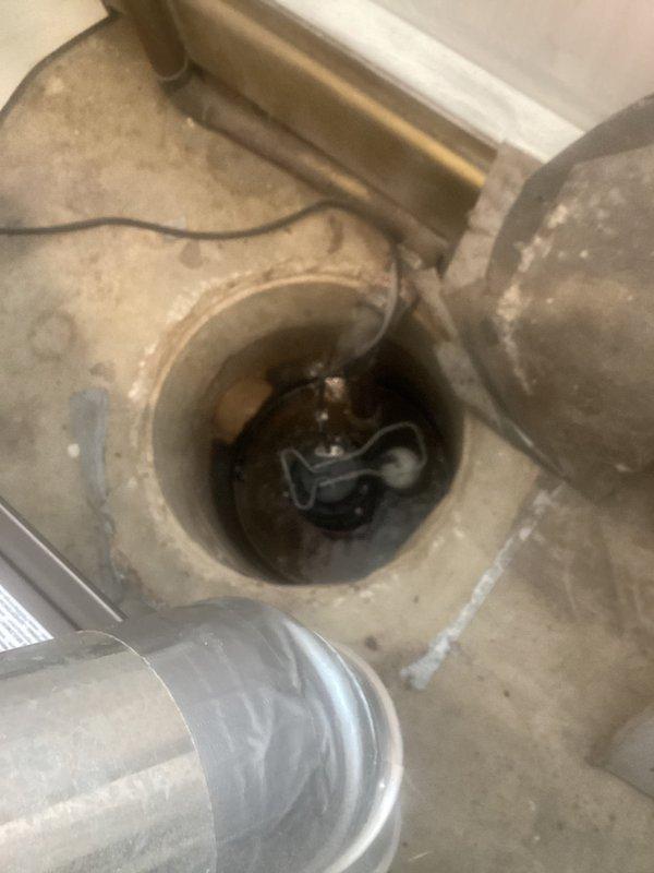 Responded to service call for sump pump running continuously. Upon arrival, performed comprehensive inspection of sump pump system and surrounding drainage components. Examined pump operation, float switch mechanism, and discharge piping. Inspected floor drain and surrounding plumbing infrastructure in basement utility area. Verified proper drainage flow and checked for obstructions or mechanical failures that could cause constant pump cycling. Documented existing conditions with photos showing exposed plumbing, copper supply lines with insulation, HVAC ductwork, floor drain opening with visible sediment accumulation, and PVC drainage components. Assessed overall system functionality to determine cause of continuous operation concern.