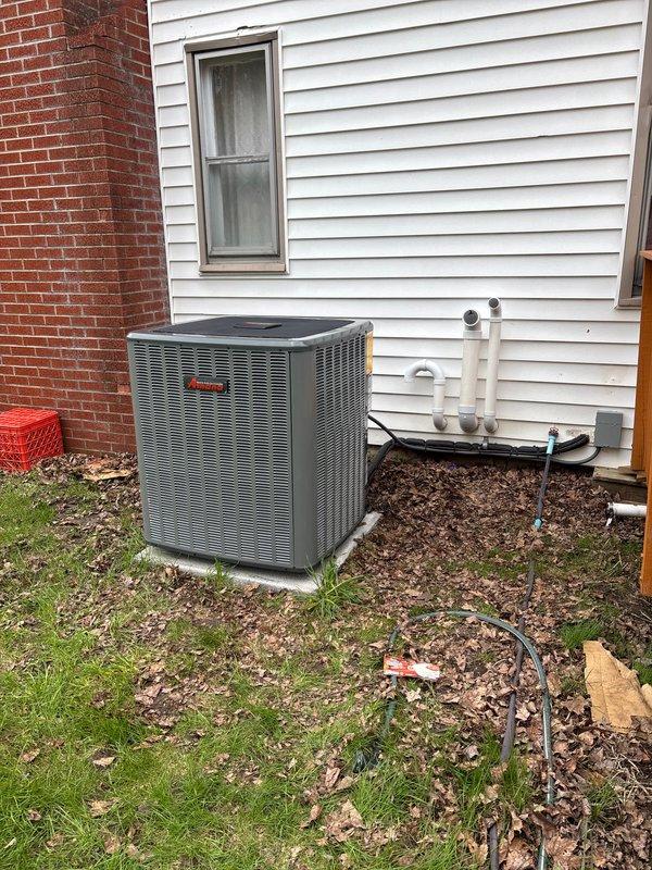 Completed full air conditioning system replacement at residential property. Installed new outdoor condensing unit on concrete pad with proper refrigerant line connections and drainage piping. Connected system to existing furnace and ductwork in basement mechanical room, ensuring proper integration with HVAC infrastructure. All electrical connections, refrigerant lines, and condensate drainage installed per manufacturer specifications. System tested and operational upon completion.