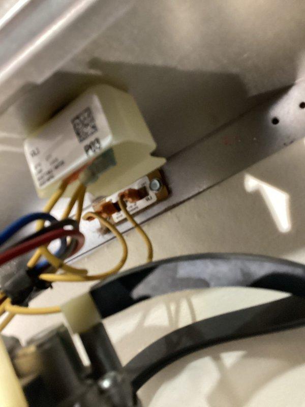Responded to no heat call on 10-year-old Trane furnace. Upon arrival, confirmed unit was not producing heat and supply air temperature at room temperature. Inspected burner assembly and found pilot light/ignition system not functioning. Examined control board and wiring connections, discovering evidence of moisture intrusion and corrosion on primary control module and wire terminals. Brown discoloration visible on white plastic connector block indicated prolonged exposure to moisture. Cleaned corroded terminals, verified all wire connections were secure, and tested control board functionality. Cycled unit through heating sequence to confirm proper ignition, burner operation, and heat output. Verified supply air temperature rising appropriately and system operating as designed.