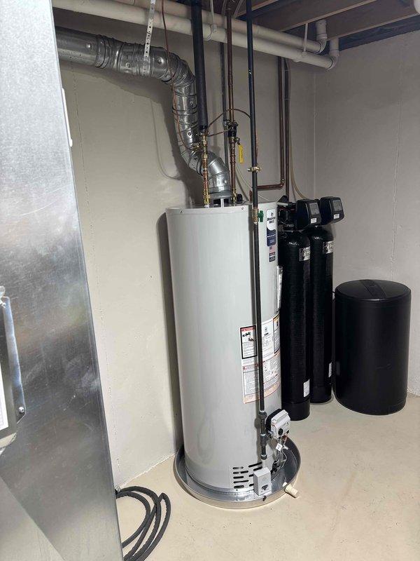 Successfully installed a 50-gallon natural gas water heater in the utility room, completing all necessary connections including copper supply lines, gas piping, and metallic flexible venting that routes to the ceiling exhaust system. The installation was integrated with existing water treatment equipment, including two vertical filtration tanks and pressure systems, ensuring proper clearances and access for future maintenance.