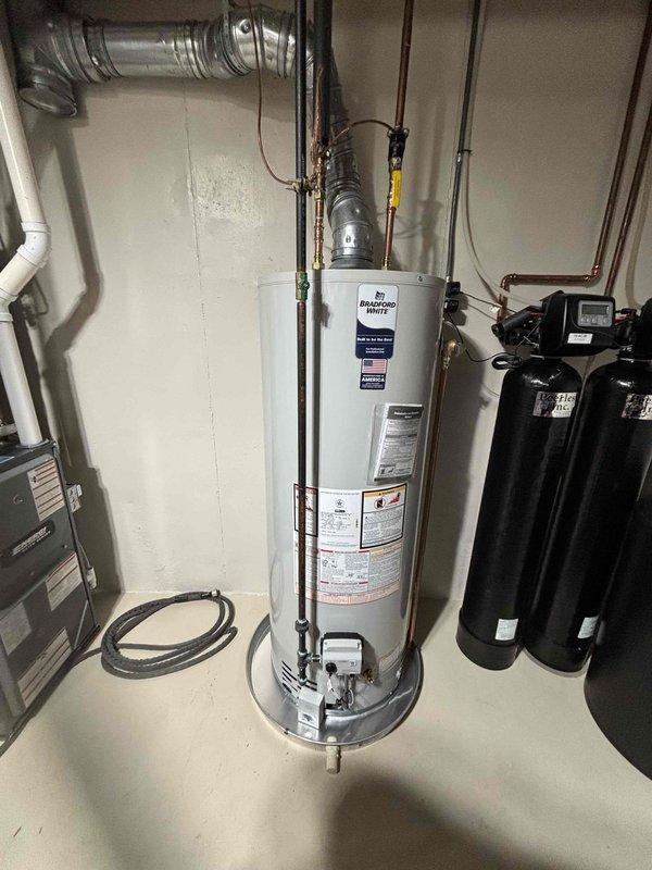 Successfully installed a 50-gallon natural gas water heater in the utility room, completing all necessary connections including copper supply lines, gas piping, and metallic flexible venting that routes to the ceiling exhaust system. The installation was integrated with existing water treatment equipment, including two vertical filtration tanks and pressure systems, ensuring proper clearances and access for future maintenance.