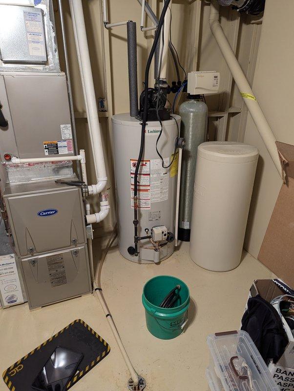 Completed comprehensive water heater tune-up and flush on an 11-year-old unit located in utility room alongside HVAC furnace and water softener system. Performed full system inspection, drained and flushed tank to remove sediment buildup, verified proper operation of temperature and pressure relief valve, checked all plumbing connections for leaks, and confirmed adequate venting. Unit returned to normal operating condition with improved efficiency.