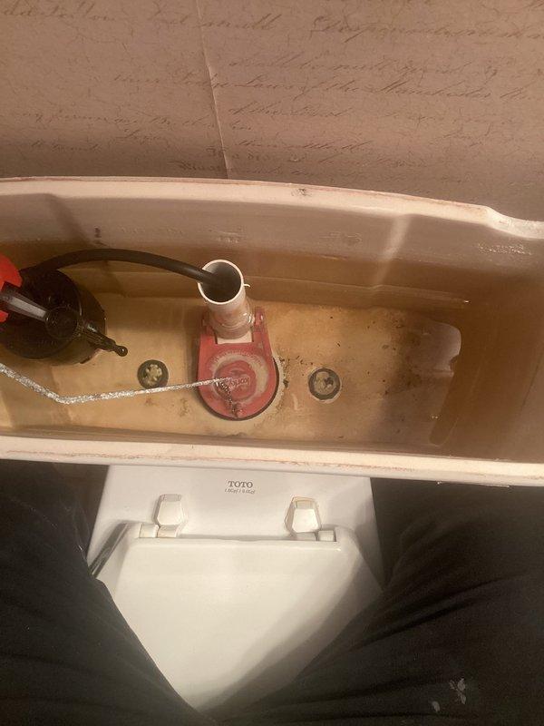 Responded to complaint of toilet running continuously after flushing in residential bathroom. Upon inspection, found worn and deteriorated flapper valve failing to properly seal against flush valve seat, allowing water to leak from tank into bowl. Flapper exhibited typical age-related degradation consistent with original 1998 installation. Replaced defective red rubber flapper with new universal flapper assembly, ensuring proper chain length and alignment with flush valve opening. Tested flush mechanism multiple times to confirm proper sealing and cessation of running water. Verified fill valve operation and water level adjustment. Toilet now functioning properly with no continuous running between flush cycles.