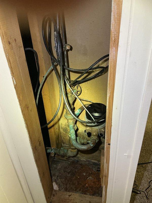 Provided comprehensive plumbing estimates for main water shut-off valve replacement, pressure regulator installation, expansion tank addition, and temperature pressure relief valve for water heater. Upon inspection, identified corroded brass components with significant oxidation in utility access area, cracked and leaking water meter requiring immediate attention, and verified existing pressure gauge readings. Water heater-related estimates may no longer be required as unit was recently replaced by another service provider.