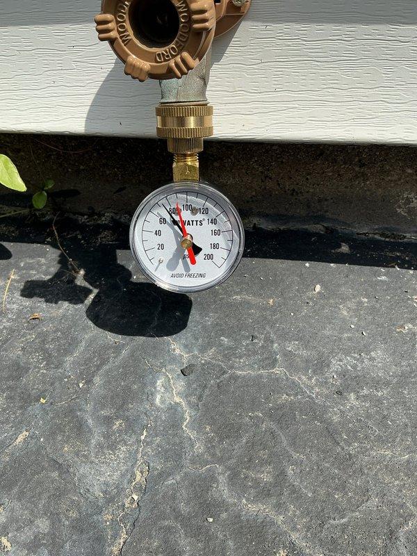 Provided comprehensive plumbing estimates for main water shut-off valve replacement, pressure regulator installation, expansion tank addition, and temperature pressure relief valve for water heater. Upon inspection, identified corroded brass components with significant oxidation in utility access area, cracked and leaking water meter requiring immediate attention, and verified existing pressure gauge readings. Water heater-related estimates may no longer be required as unit was recently replaced by another service provider.