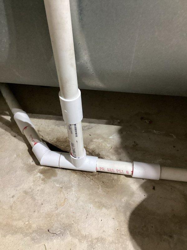 Completed comprehensive annual heating and cooling maintenance visit including tune-up services for air conditioning system, furnace, and humidifier. Performed standard preventive maintenance procedures, inspected all equipment components, and verified proper operation of HVAC systems. Documented condensate drain line configuration with PVC piping installation showing proper drainage setup in mechanical area. All systems tested and confirmed to be functioning within normal operating parameters.