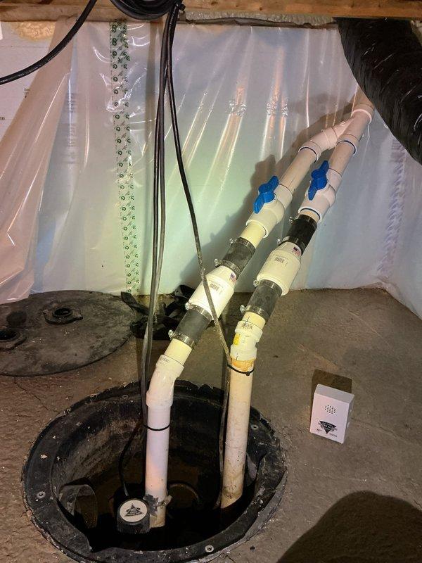 Responded to service call for non-operational sump pump causing basement dampness. Upon inspection, determined pump failure resulted from recent power surge damage. Verified sump basin, discharge piping with blue-handled valves, and PVC plumbing configuration. Documented existing single-pump system with yellow submersible pump in concrete basin. Provided estimate for battery backup sump pump system installation to prevent future power outage failures and protect against water intrusion.
