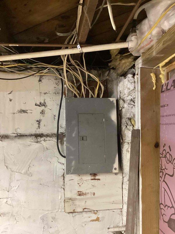 Conducted comprehensive site evaluation for potential central air conditioning installation and furnace maintenance assessment. Inspected existing 9-year-old mini-split AC system, evaluated electrical service capacity at exterior meter location, and assessed basement mechanical room infrastructure including electrical panel, ductwork routing, and available space for HVAC equipment installation. Documented current utility configuration, examined exposed ceiling structure and existing duct runs to determine feasibility of converting to or adding split system AC while utilizing present ductwork, and provided professional recommendations on most efficient upgrade path forward considering existing infrastructure limitations and mechanical system compatibility.