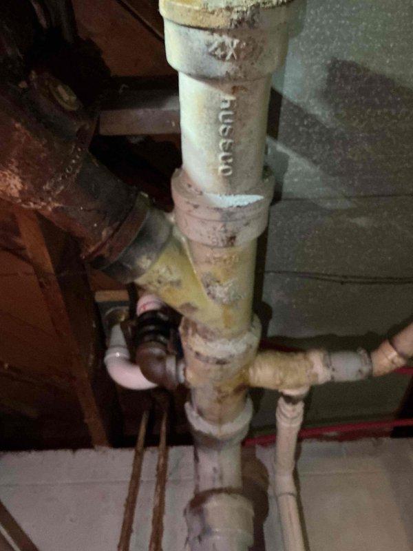 Completed sales estimate for main sewer pipe replacement in basement. Inspected and documented existing plumbing system, which showed significant aging with rust, corrosion, and discoloration on multiple pipe sections including vertical PVC stack and horizontal branch lines. Photographed deteriorated plumbing infrastructure to support estimate preparation, noting that property owner has city grant funding available for the project.