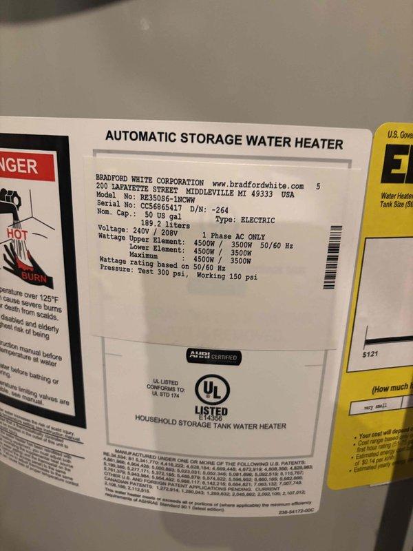 Successfully installed a 50-gallon Bradford White electric water heater (Model RE350S6-1NCWH) with 4500W/3500W dual heating elements in basement utility area. Installation included integration with existing water treatment system consisting of blue pressure tank and water softener/filtration unit, connected via copper piping with appropriate fittings and valves. Added domestic hot water expansion tank to system per code requirements to protect against thermal expansion and maintain proper system pressure.