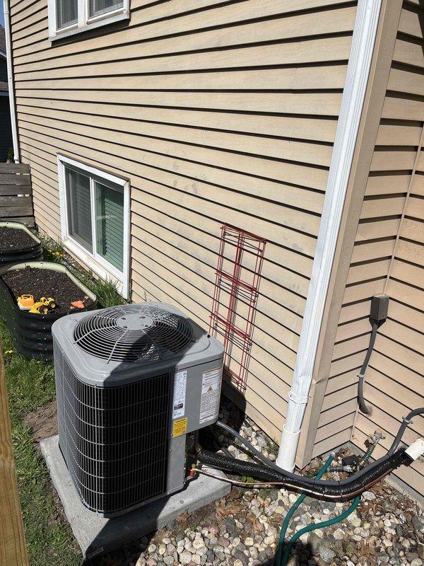 Completed full HVAC system replacement including installation of new Ruud furnace unit in basement utility area and outdoor condensing unit on concrete pad. Installed all refrigerant line sets with proper insulation, white PVC condensate drainage piping, and black corrugated drain lines with appropriate fittings and connections. Mounted outdoor condenser unit with protective line set guard, connected all electrical components, and verified proper system operation upon startup.