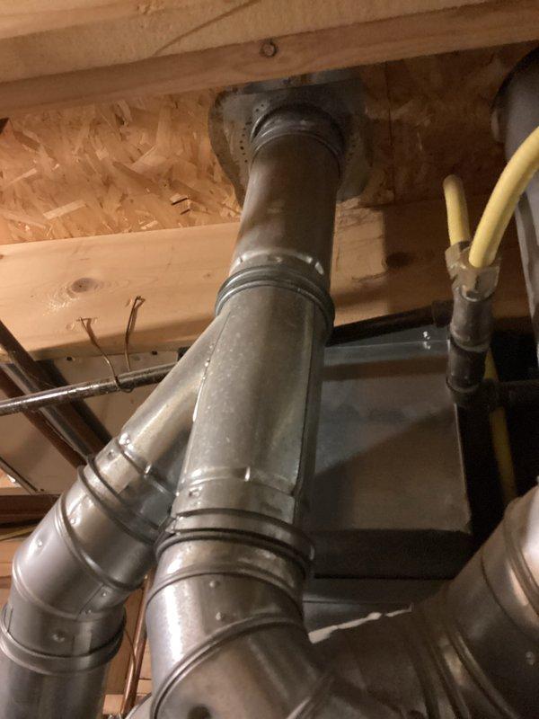 Completed estimate for water heater replacement in residential basement mechanical room. Inspected existing Bradford White water heater with Defender Safety System, documented current installation including copper supply piping, valve configurations, and venting connections. Assessed mechanical room layout with adjacent HVAC ductwork and equipment to determine replacement requirements and clearances for new unit installation.