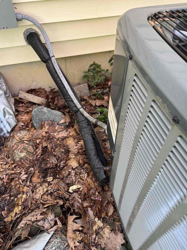 Conducted site evaluation of outdoor air conditioning condenser unit to assess relocation options for upcoming exterior home remodeling project. Documented current installation configuration including unit positioning against vinyl siding, electrical conduit routing, refrigerant line set configuration, and concrete pad placement. Photographed existing setup showing condensate drain line, power supply connections, and clearance measurements from structure. Discussed temporary relocation procedures with client, explaining that unit can be moved short distances by extending refrigerant lines and electrical connections, or alternatively can be temporarily disconnected and relocated to adjacent area with proper line set protection and electrical safety measures during construction period. Advised on importance of maintaining proper clearances, level pad placement, and protection of refrigerant lines during any relocation work. Recommended scheduling air conditioning performance check follow