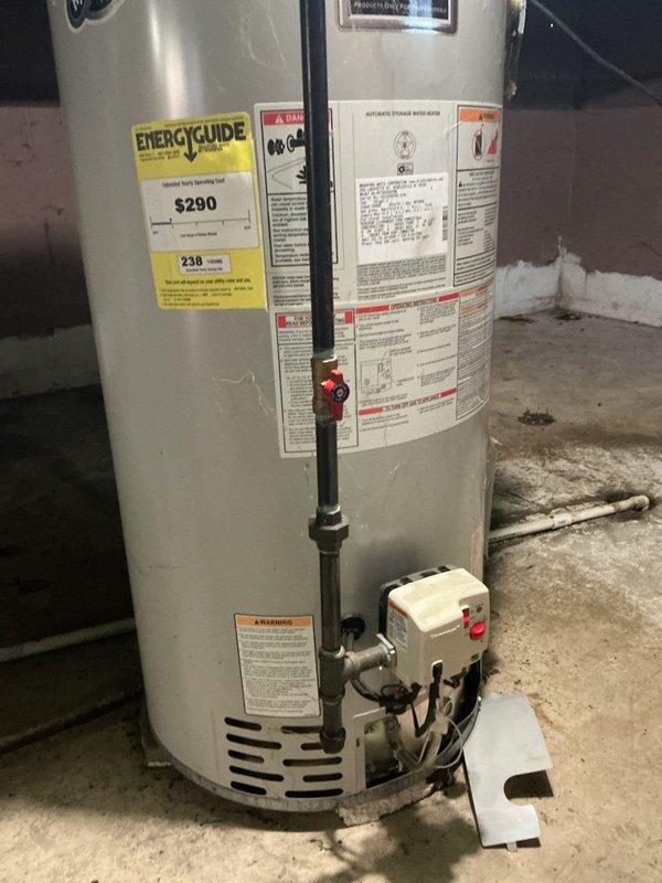 Responded to service call for non-operational Honeywell water heater with 7-flash error code in flooded basement. Upon arrival, found 9-year-old unit with standing water around base. The 7-flash diagnostic code indicated a gas control valve failure requiring immediate attention. Assessed both the primary water heater and adjacent Bradford White unit for flood damage. Documented equipment condition, manufacturer labels, and installation configuration including copper supply lines, gas piping, and venting system. Photographed EnergyGuide labels, control assemblies, and basement utility area showing water damage on concrete floor. Recommended gas valve replacement or full unit replacement based on age and flood exposure to electrical components and insulation.