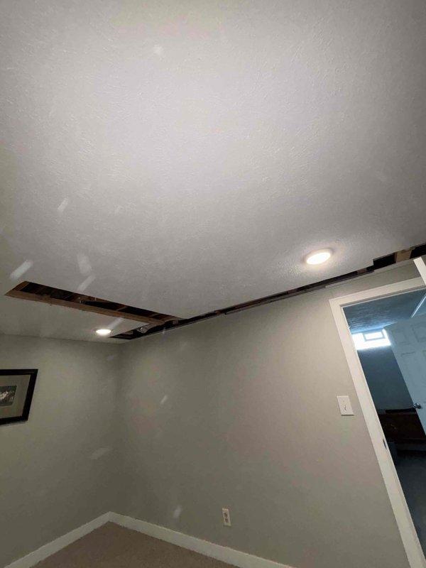 # Plumbing Project Install

Completed drain work installation in basement area, routing new PVC drain lines through exposed ceiling joists using proper hanger strapping and support systems. Installed horizontal drain piping with appropriate slope and secured all lines to structural members per code requirements. Project documented with photos showing completed rough-in plumbing infrastructure ready for inspection.