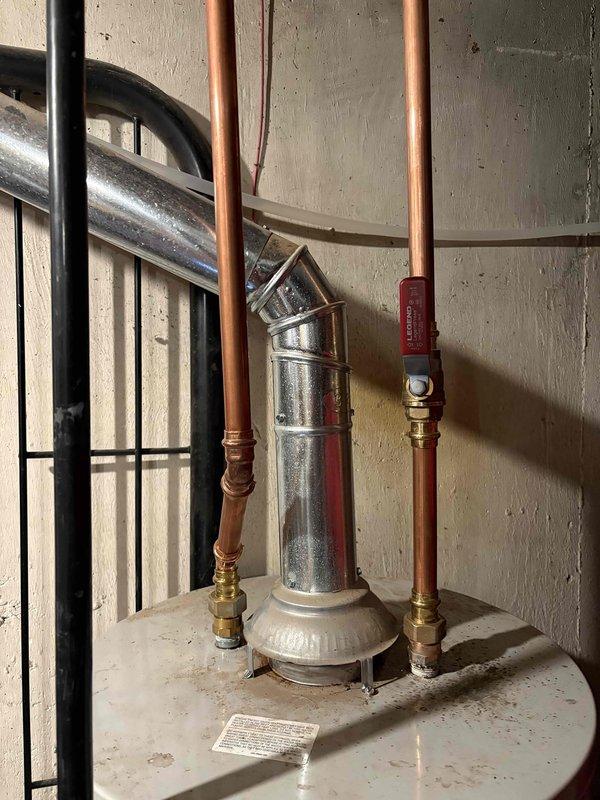 Responded to service call for 13-year-old water heater that failed to reignite. Upon inspection, documented existing installation including copper supply lines, pressure relief valve, and venting system. Unit was assessed and determined to be at end of serviceable life, unable to maintain reliable ignition. Provided documentation and recommendations for replacement options.