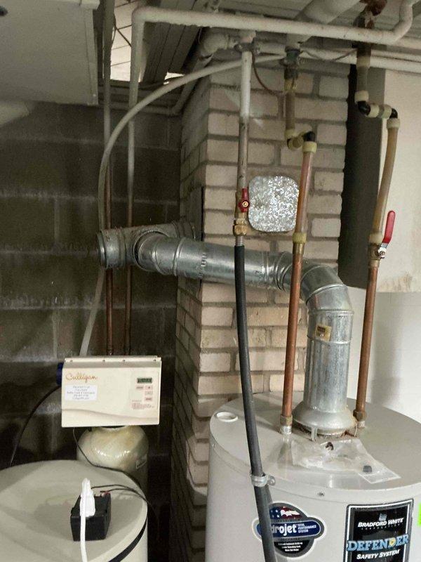 Responded to customer concern regarding corroded copper piping at water heater connection with history of previous minor leaking. Performed thorough inspection of water heater copper supply lines, connections, and fittings for active leaks, corrosion damage, and structural integrity. Examined pipe condition at inlet/outlet connections and assessed severity of oxidation on copper components. Documented current state of plumbing system with photographic evidence showing water heater installation, associated piping, and mechanical room configuration for customer records.