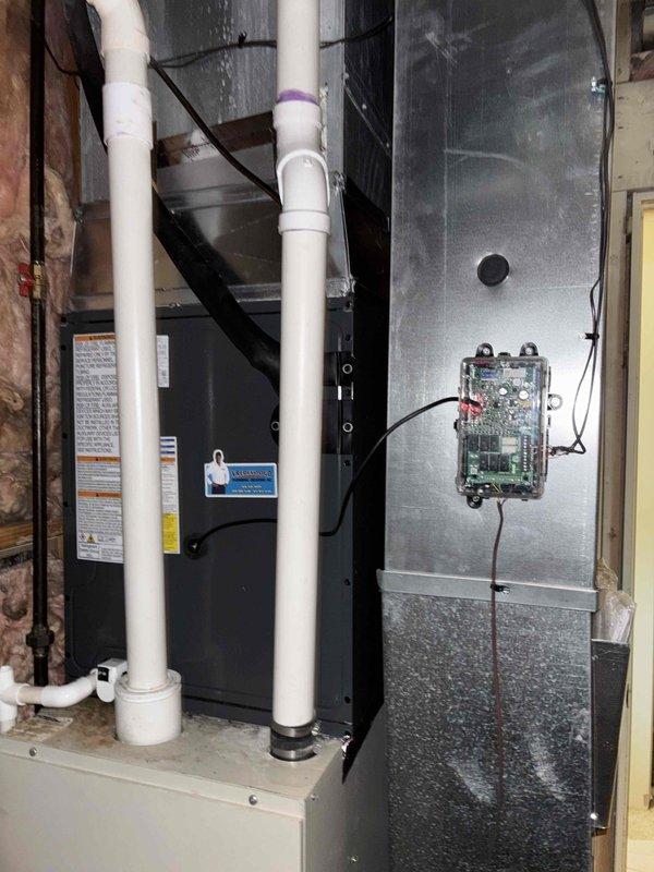 Completed full furnace installation in residential basement utility area. Installed air handler unit with proper mounting and secured all electrical connections including control board module. Ran and secured PVC condensate drain lines with appropriate coupling joints and primer application. Verified all safety labels and documentation are visible and properly affixed to equipment. Connected ductwork and completed all wiring terminations. Obtained and documented customer identification for financing records. System installation complete and ready for operation.