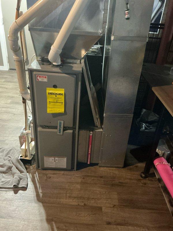 Conducted comprehensive evaluation of existing 16-year-old HVAC system including furnace and air conditioning unit to assess replacement needs and provide equipment recommendations. Inspected current system installation, ductwork configuration, venting arrangement with PVC piping, and supporting mechanical components in basement utility area to determine proper sizing and compatibility requirements for new equipment installation.