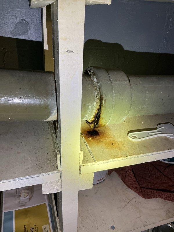 Responded to report of multiple small leaks throughout residence with primary concern regarding spongy wall condition in downstairs bathroom. Upon inspection, identified significant water damage and rust-colored staining on HVAC ductwork at joint connection in mechanical area, indicating active leak from compromised duct seam. Staining pattern showed vertical streaking consistent with ongoing moisture intrusion affecting surrounding building materials. Investigated downstairs bathroom area with pedestal sink installation; inspected plumbing fixtures, supply lines, and drain connections for potential leak sources contributing to wall deterioration. Documented conditions with photographs showing extent of water damage to ductwork system and bathroom fixture configuration for repair recommendations and follow-up remediation work.