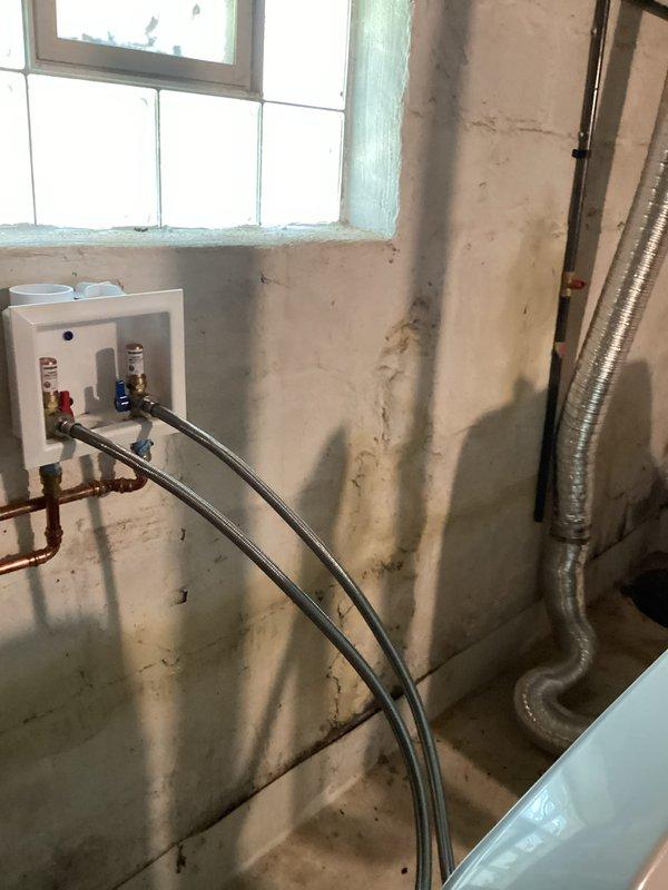 Conducted site assessment for electrical dryer hookup installation in basement utility area. Documented existing laundry area conditions, including current plumbing connections, ventilation ductwork, and available electrical infrastructure. Identified water damage and mold growth on adjacent walls requiring remediation before electrical work can proceed safely, and photographed utility room layout to prepare comprehensive project estimate for complete dryer installation.