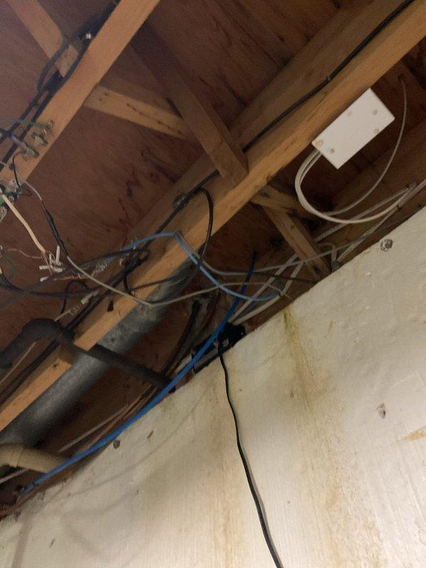 Responded to plumbing leak concern involving reverse osmosis system and potential beverage dispenser connection. Upon inspection, located leak source in under-sink cabinet area affecting garbage disposal plumbing connections and surrounding fixtures. Identified water damage and staining on cabinet floor indicating previous moisture exposure. Examined all connections including PVC drain lines, rubber hoses, water supply lines, and disposal unit fittings. Traced plumbing lines through ceiling cavity to verify system integrity and rule out secondary leak points. Documented existing conditions with photographic evidence showing cabinet interior, disposal assembly, electrical connections, and overhead plumbing runs. Addressed leak at source connection point and verified all related plumbing components for proper operation.