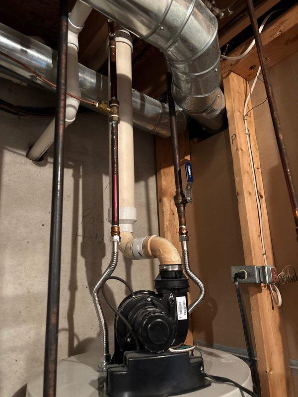 Provided estimate for tankless water heater replacement to replace existing Lochinvar tank-style water heater unit currently installed in basement utility area. Evaluated existing plumbing configuration including copper supply lines, pump assembly connections, and venting requirements for proper tankless unit installation.