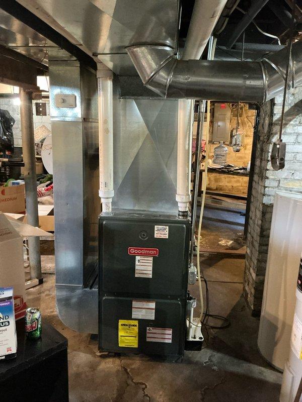 Conducted comprehensive assessment of existing HVAC system for air conditioning estimate. Documented current Goodman furnace installation in basement utility area, including extensive ductwork configuration and electrical service panel with main breaker and circuit distribution. Evaluated equipment condition, spatial constraints, and electrical capacity to determine requirements for proposed AC system integration with existing forced-air heating infrastructure.