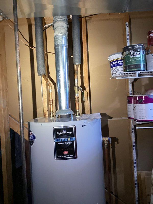 Responded to complaint of knocking noise in plumbing pipes throughout house when using hot or cold water, occurring after recent technician visit. Upon arrival, performed diagnostic assessment of plumbing system in 1997-built home, focusing on left side of structure where noise was primarily reported. Tested static water pressure at hose bib using calibrated pressure gauge to determine if excessive pressure was causing water hammer condition. Inspected Bradford White water heater installation, copper supply lines, and associated plumbing connections in mechanical room for loose pipes, inadequate securing, or missing water hammer arrestors. Verified proper pipe support and checked for thermal expansion issues that could contribute to knocking sounds. Documented system pressure readings and condition of plumbing infrastructure with photographic evidence. Provided findings and recommendations to address the water hammer condition in the residential plumbing system.