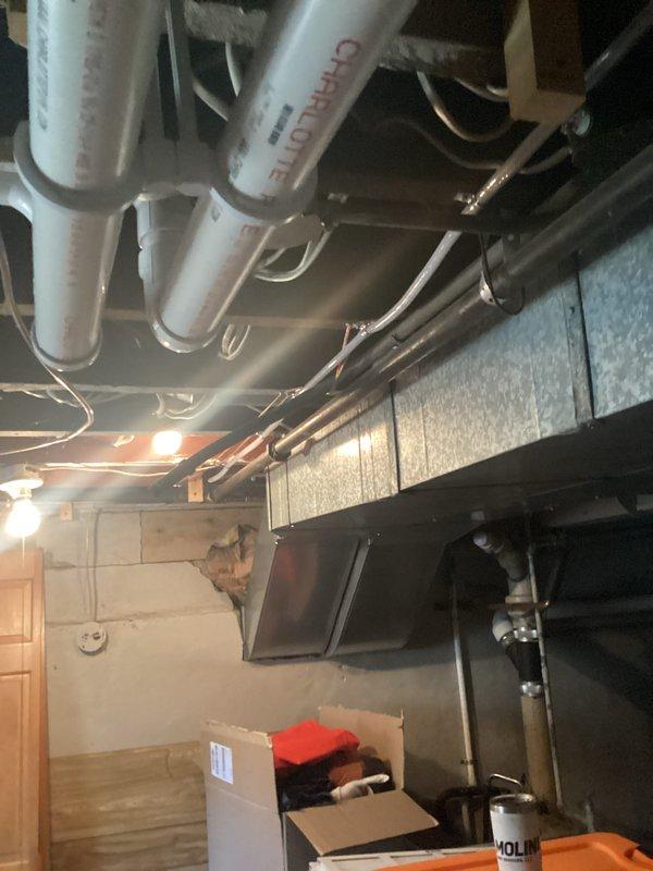 Completed full HVAC system installation in basement mechanical room, including new residential furnace unit and air conditioning system. Installed all required PVC ventilation piping, metal ductwork, and associated plumbing connections running to ceiling joists with proper support brackets and straps. System tested and verified operational upon completion.