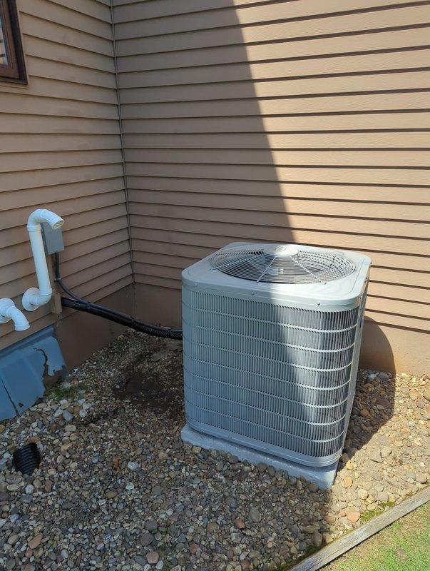 Completed full HVAC system installation including new Carrier furnace and outdoor air conditioning condenser unit. Installed furnace in basement utility area with proper ductwork connections and electrical hookups. Mounted and configured digital thermostat control panel. Installed outdoor condenser unit on concrete pad with gravel base in exterior corner location. Connected refrigerant lines, drainage system with PVC piping, and completed all necessary electrical connections. Verified proper operation of both heating and cooling systems. All equipment installed per manufacturer specifications and local code requirements.