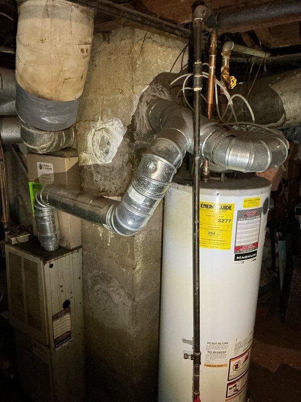 Conducted on-site estimate for air conditioning system and water heater replacement in residential property. Evaluated existing HVAC furnace unit with connected ductwork system and aging cylindrical water heater in basement mechanical room. Documented current equipment conditions through photographic assessment and discussed replacement options with tenant, coordinating availability for technical consultation via phone regarding AC and water heater upgrade specifications.