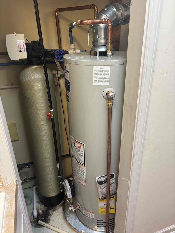 Completed full HVAC system installation including new Carrier furnace and air conditioning unit in residential utility closet. Installed stacked air handler configuration with integrated control panel and thermostat interface, ensuring proper mounting, electrical connections, and ductwork integration with black flexible ducting and metal brackets. Configured all necessary PVC drainage lines, verified proper clearances in mechanical room space, and confirmed system operation with all manufacturer specifications met for heating and cooling functionality.